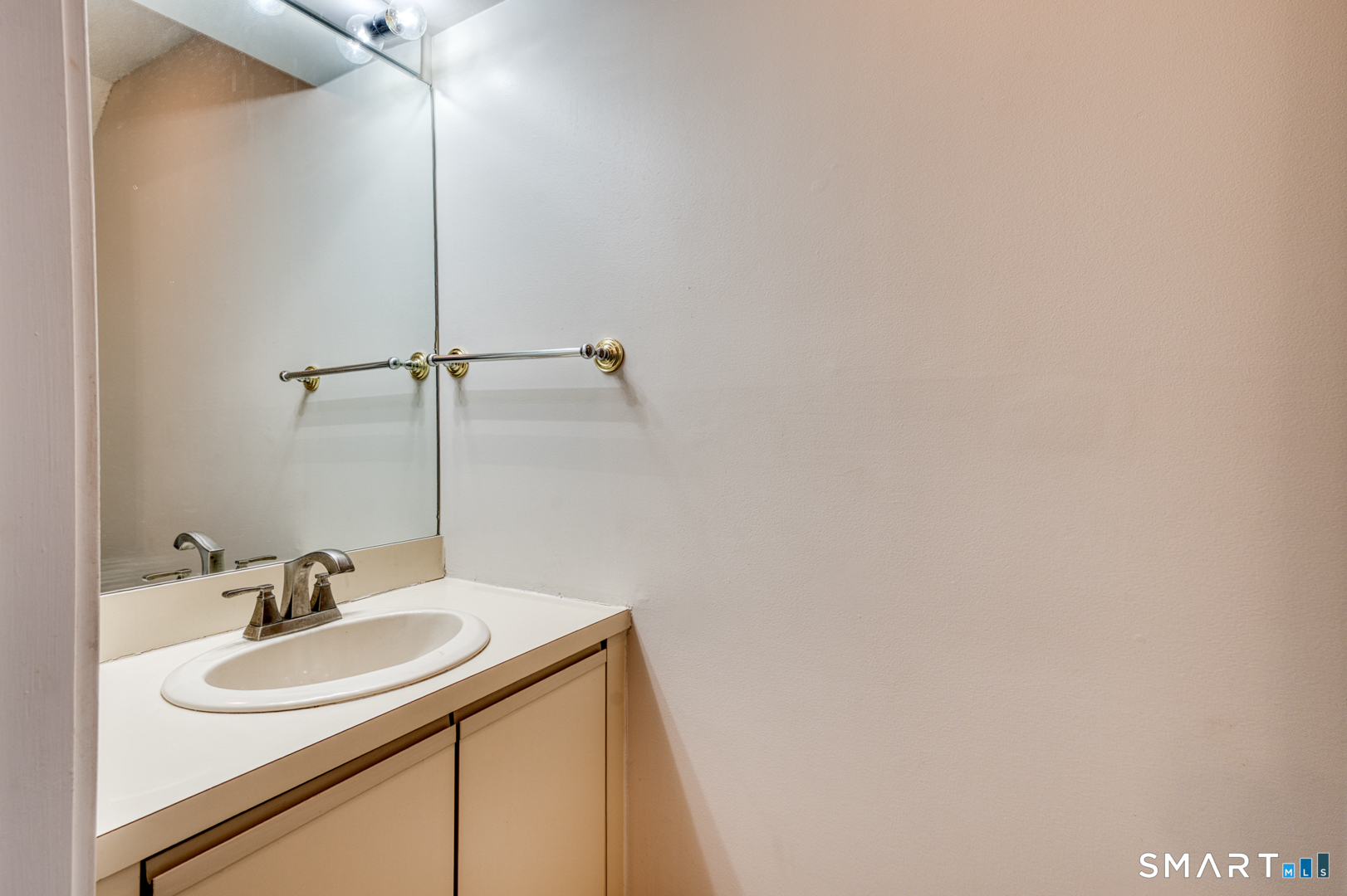 35 Riveredge Drive, Unit 35 Winsted, CT 06098 - Photo 18 of 33 a bathroom with a sink and a mirror