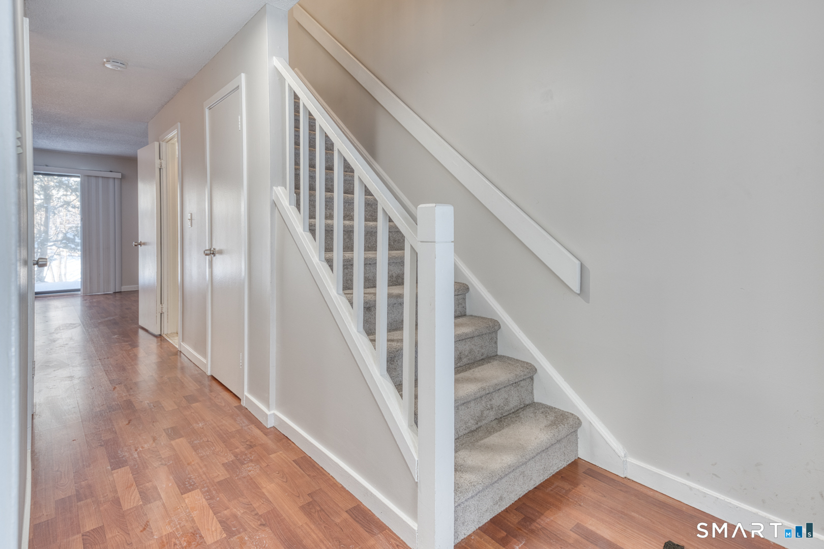 35 Riveredge Drive, Unit 35 Winsted, CT 06098 - Photo 19 of 33 a view of staircase with wooden floor and white walls
