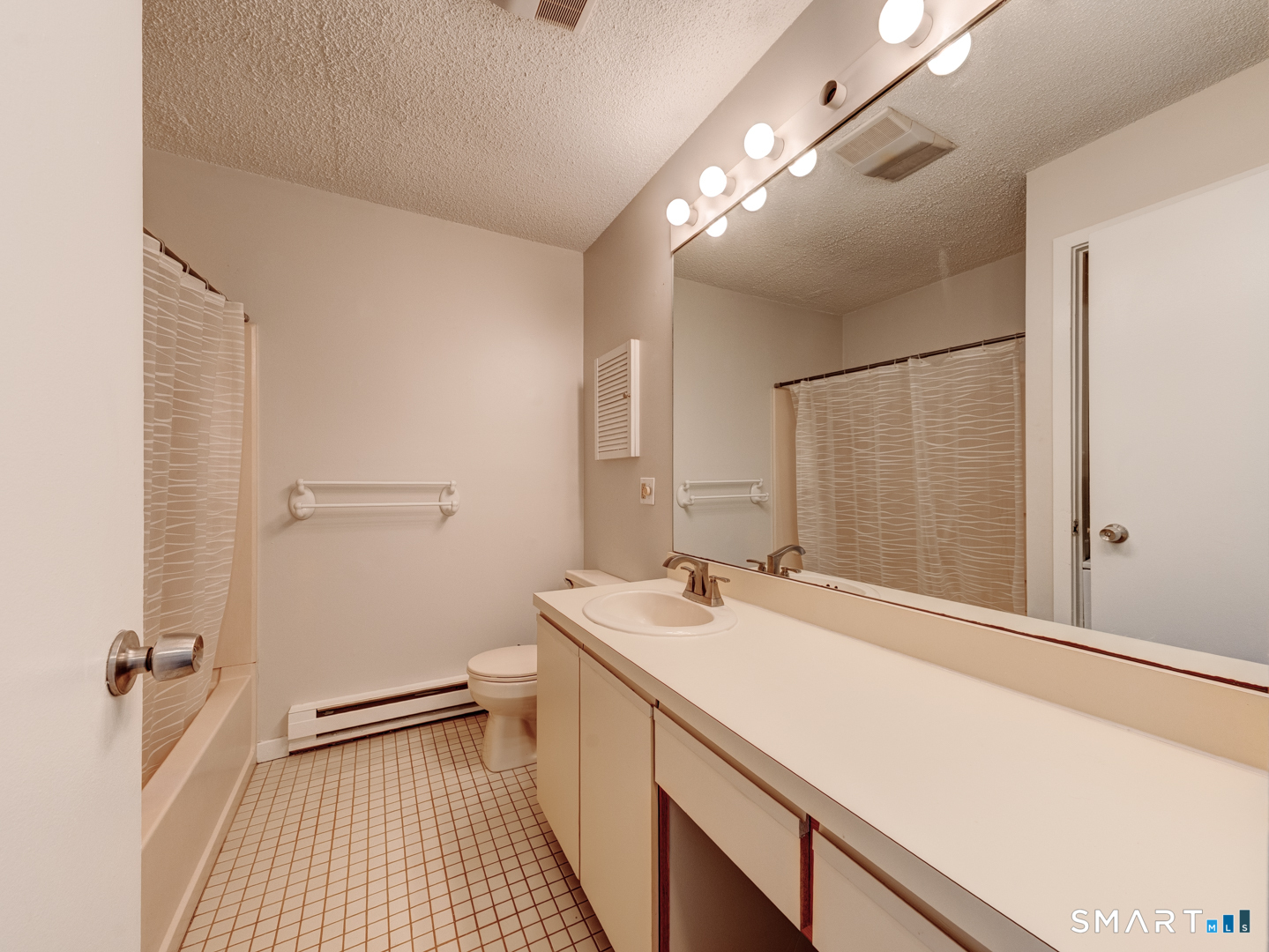 35 Riveredge Drive, Unit 35 Winsted, CT 06098 - Photo 24 of 33 a bathroom with a sink and a mirror