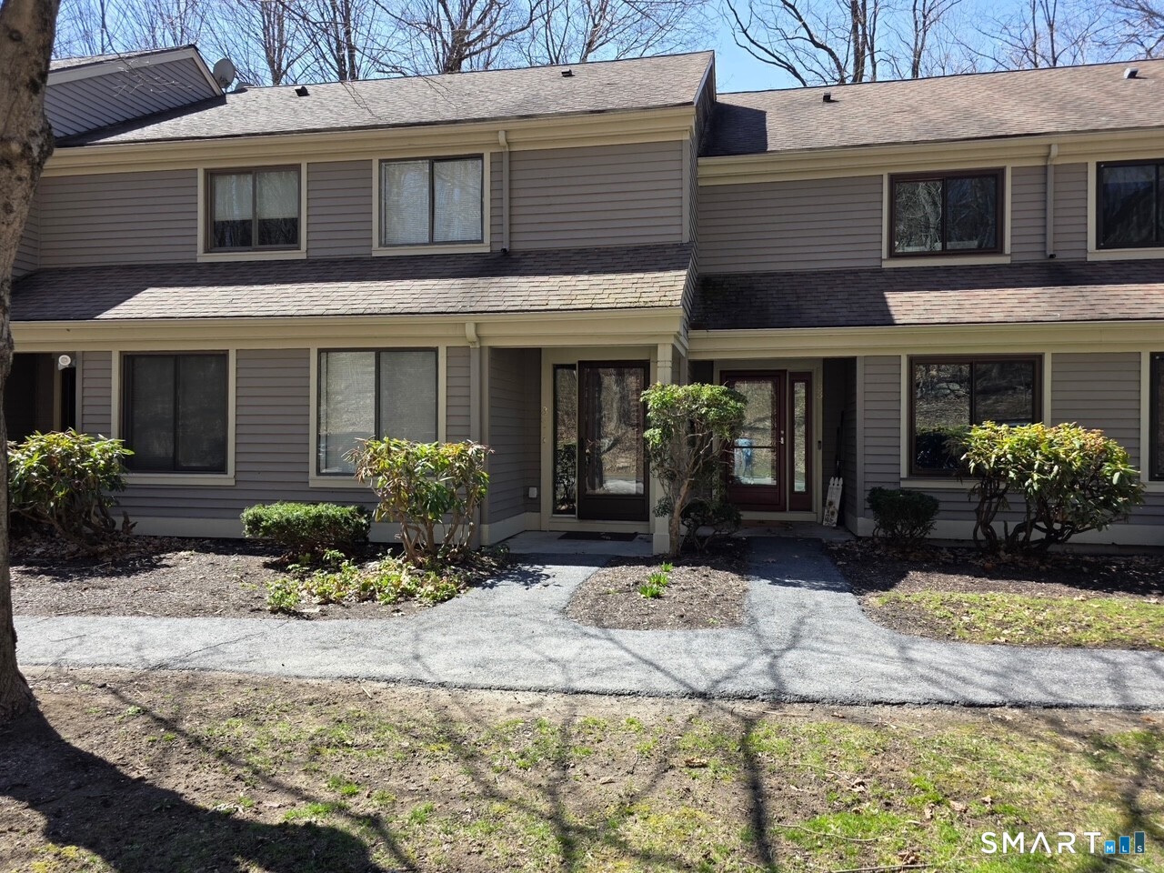 35 Riveredge Drive, Unit 35 Winsted, CT 06098 - Photo 4 of 33 a view of a house with potted plants and a large tree