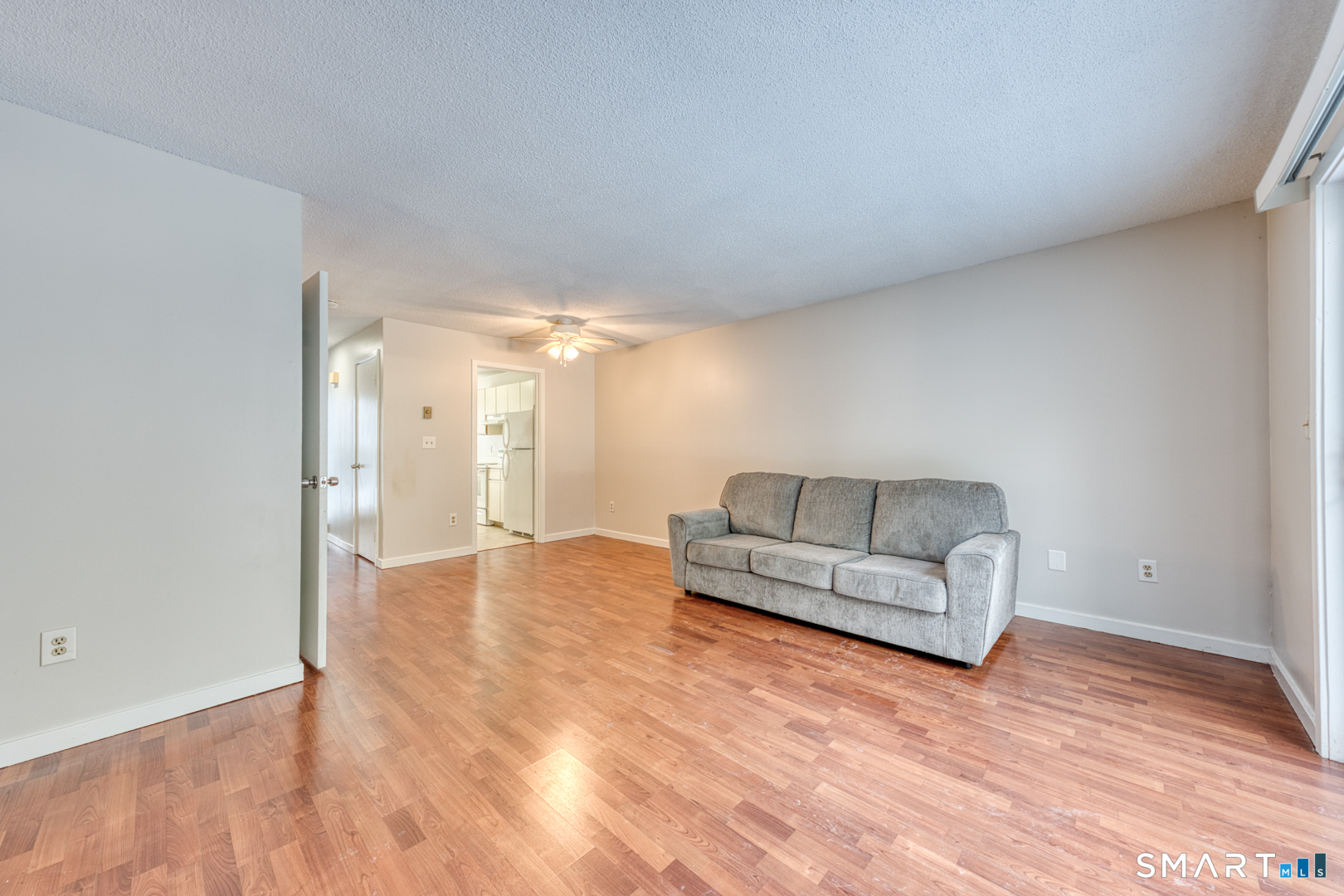 35 Riveredge Drive, Unit 35 Winsted, CT 06098 - Photo 9 of 33 a living room with furniture and a wooden floor