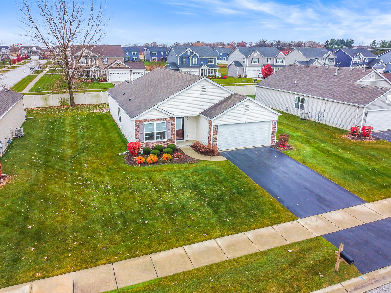 515 East 117th Place Crown Point, IN 46307 - Photo 2 of 35 an aerial view of residential houses with yard and mountain view in back