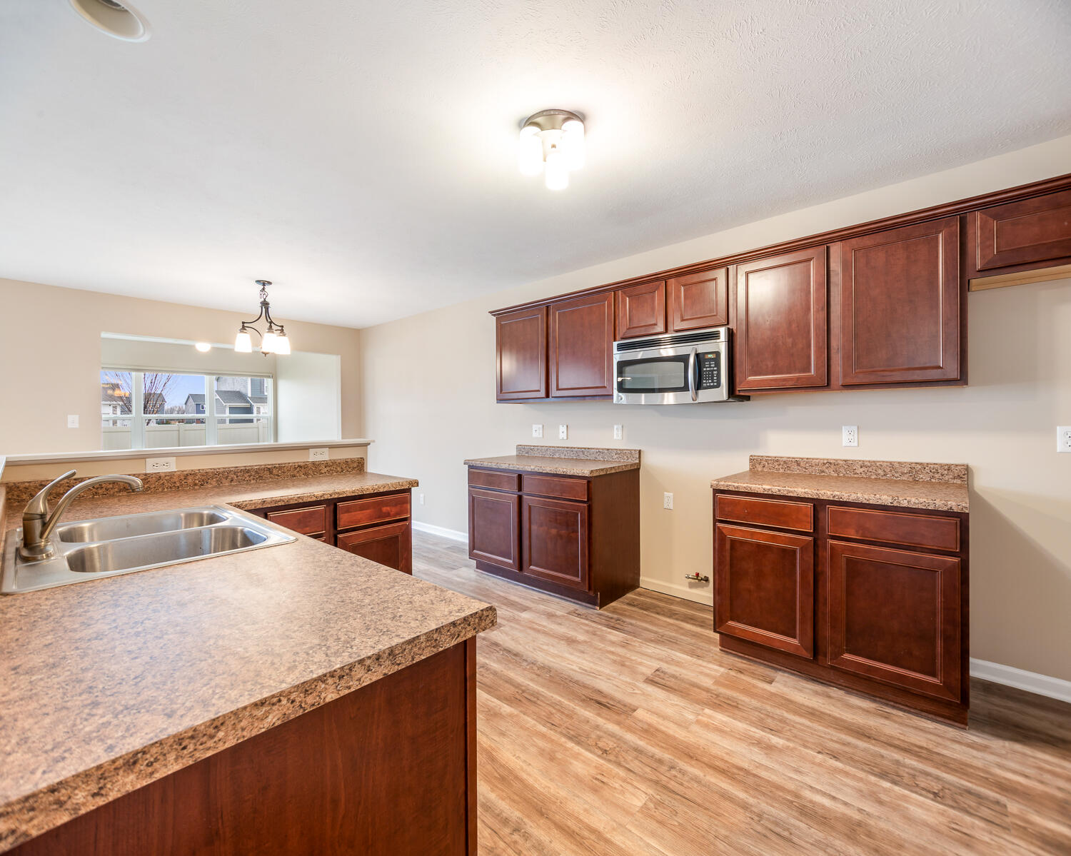 515 East 117th Place Crown Point, IN 46307 - Photo 23 of 35 a kitchen with stainless steel appliances granite countertop a sink stove and microwave