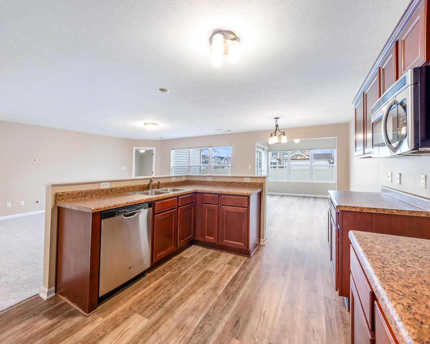 515 East 117th Place Crown Point, IN 46307 - Photo 24 of 35 a kitchen with stainless steel appliances granite countertop a stove and a wooden floors