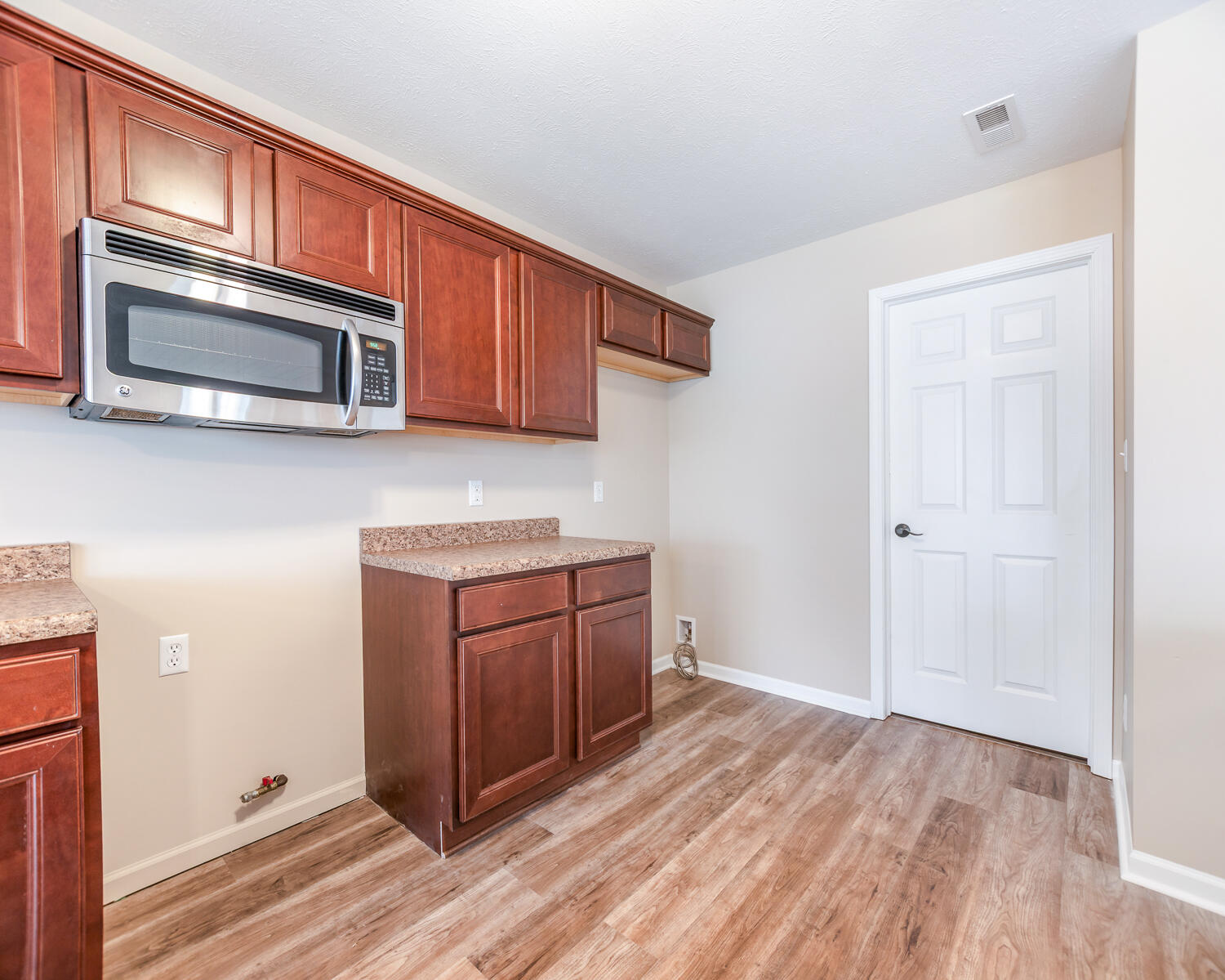 515 East 117th Place Crown Point, IN 46307 - Photo 26 of 35 a kitchen with stainless steel appliances granite countertop cabinets and wooden floor