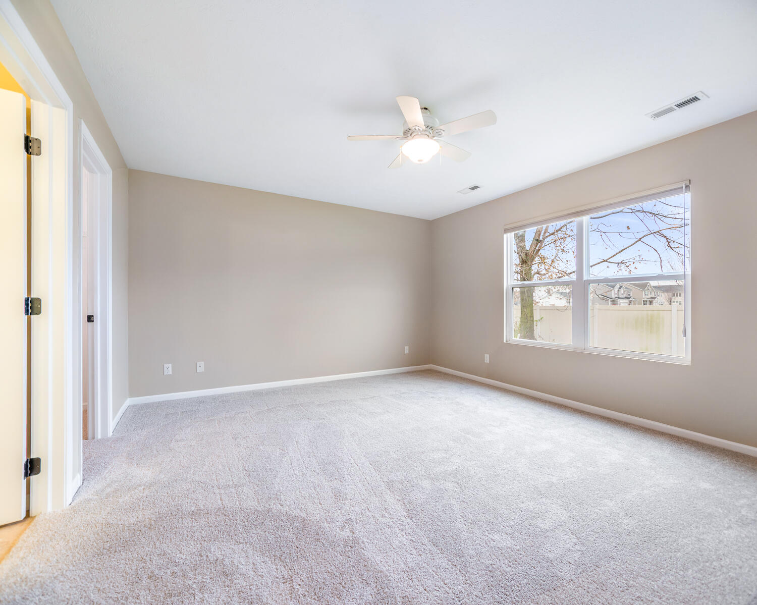 515 East 117th Place Crown Point, IN 46307 - Photo 29 of 35 an empty room with windows and chandelier fan