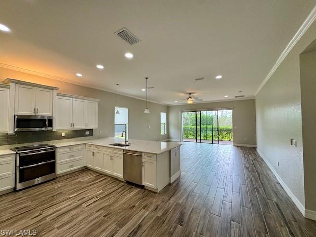 2820 Cinnamon Bay Circle Naples, FL 34119 - Photo 16 of 27 a kitchen with stainless steel appliances granite countertop a stove and cabinets