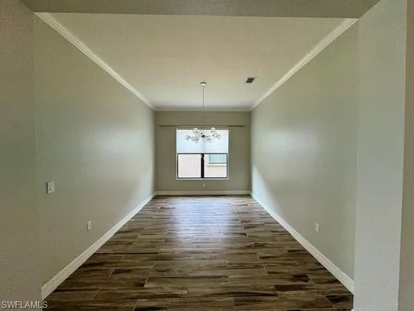 wooden floor in an empty room with window