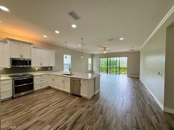 a kitchen with a sink and steel stove top oven