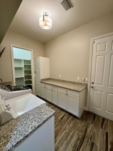2820 Cinnamon Bay Circle Naples, FL 34119 - Photo 21 of 27 a spacious bathroom with a granite countertop sink and a mirror