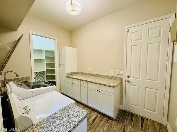 a room with a sink and a dresser