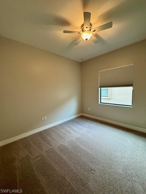 2820 Cinnamon Bay Circle Naples, FL 34119 - Photo 24 of 27 an empty room with windows and fan