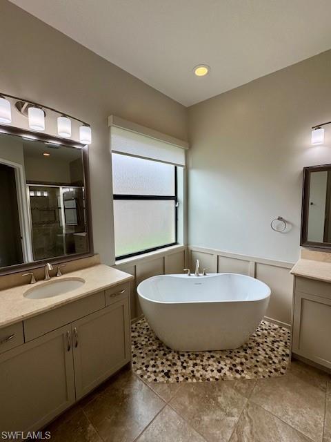 2820 Cinnamon Bay Circle Naples, FL 34119 - Photo 5 of 27 a spacious bathroom with a double vanity sink and a mirror