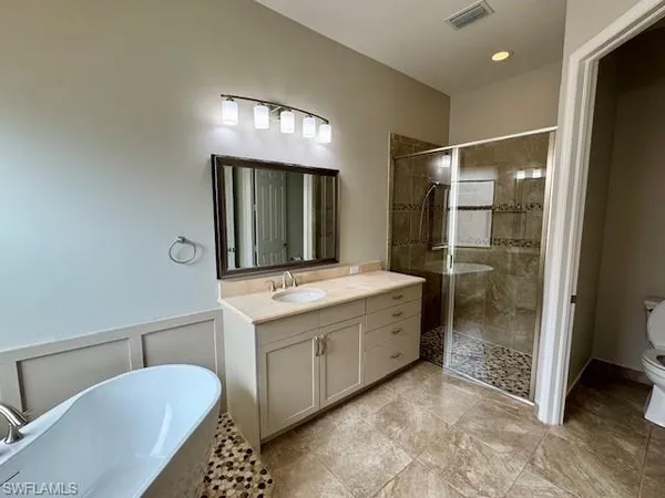 a bathroom with a granite countertop sink mirror and shower