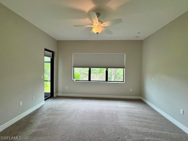 2820 Cinnamon Bay Circle Naples, FL 34119 - Photo 10 of 27 an empty room with a window and a ceiling fan