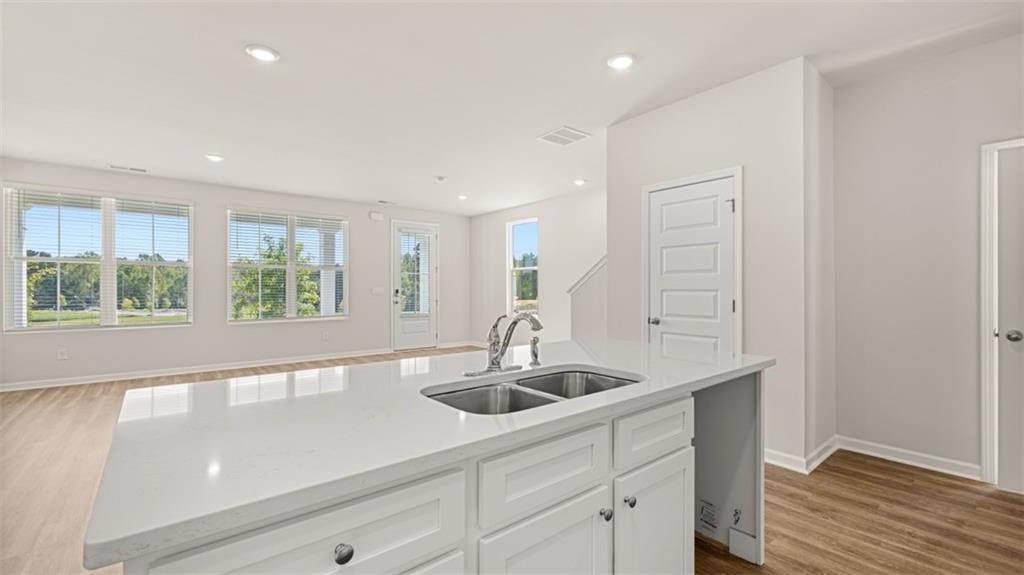 906 Stow Lane Monroe, GA 30655 - Photo 12 of 28 a kitchen with stainless steel appliances granite countertop a sink and a window