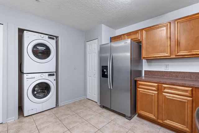 a kitchen with stainless steel appliances granite countertop a stove top oven a sink dishwasher and a microwave oven on the blue kitchen countertops