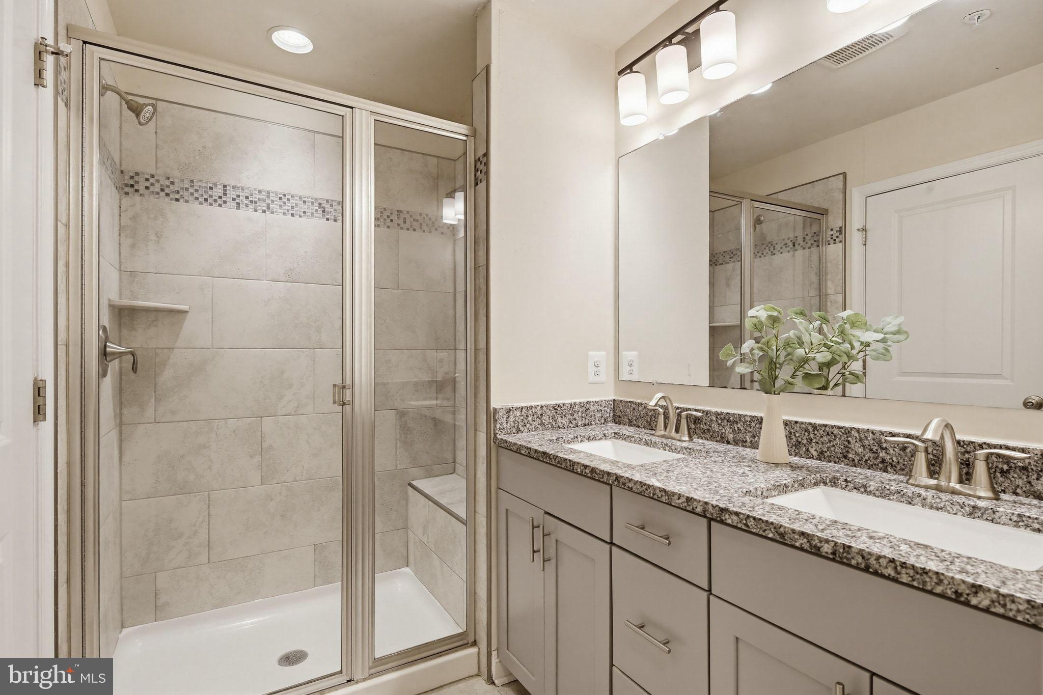 5057 East Joppa Road Perry Hall, MD 21128 - Photo 14 of 29 a bathroom with a granite countertop sink mirror and shower