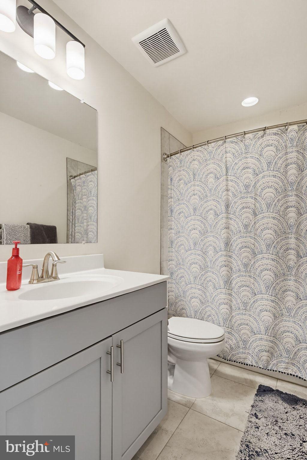 5057 East Joppa Road Perry Hall, MD 21128 - Photo 20 of 29 a bathroom with a sink a toilet and a mirror