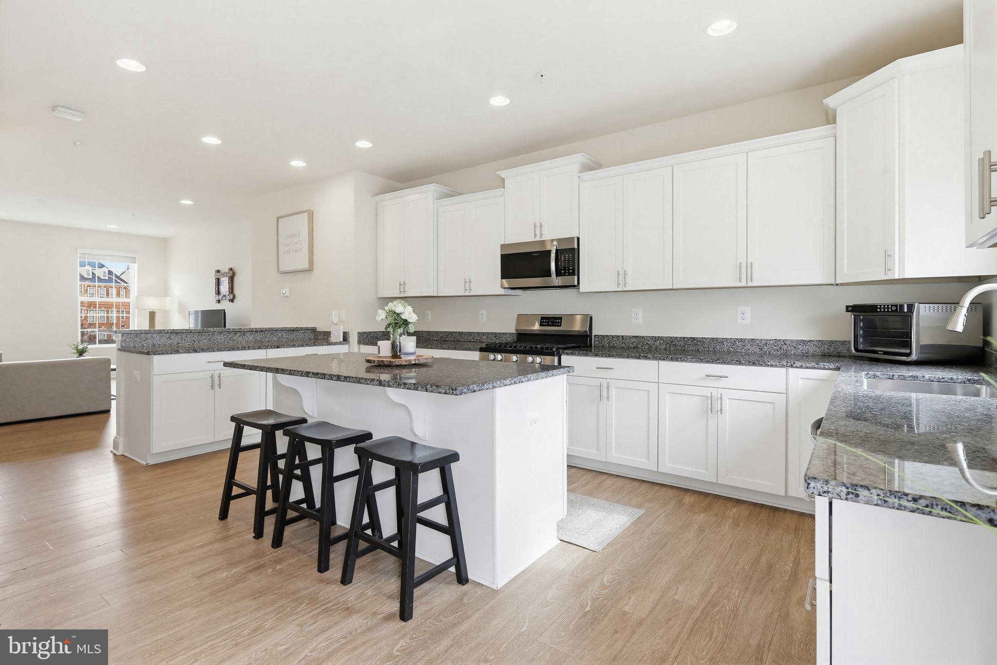 5057 East Joppa Road Perry Hall, MD 21128 - Photo 2 of 29 a kitchen with a sink white cabinets and white appliances