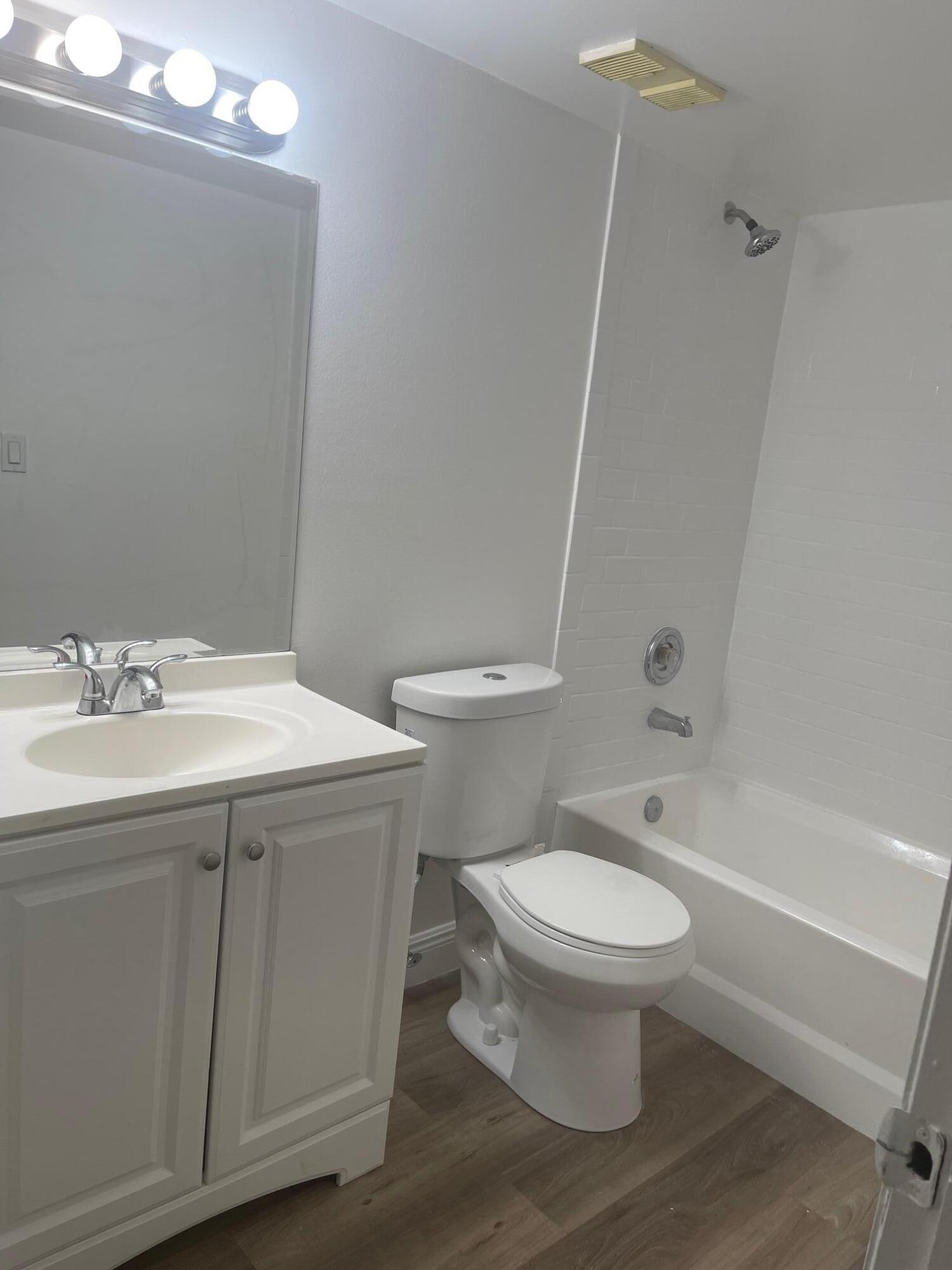 1089 Benoist Farms Road, Unit 207 West Palm Beach, FL 33411 - Photo 14 of 21 a bathroom with a sink toilet and shower