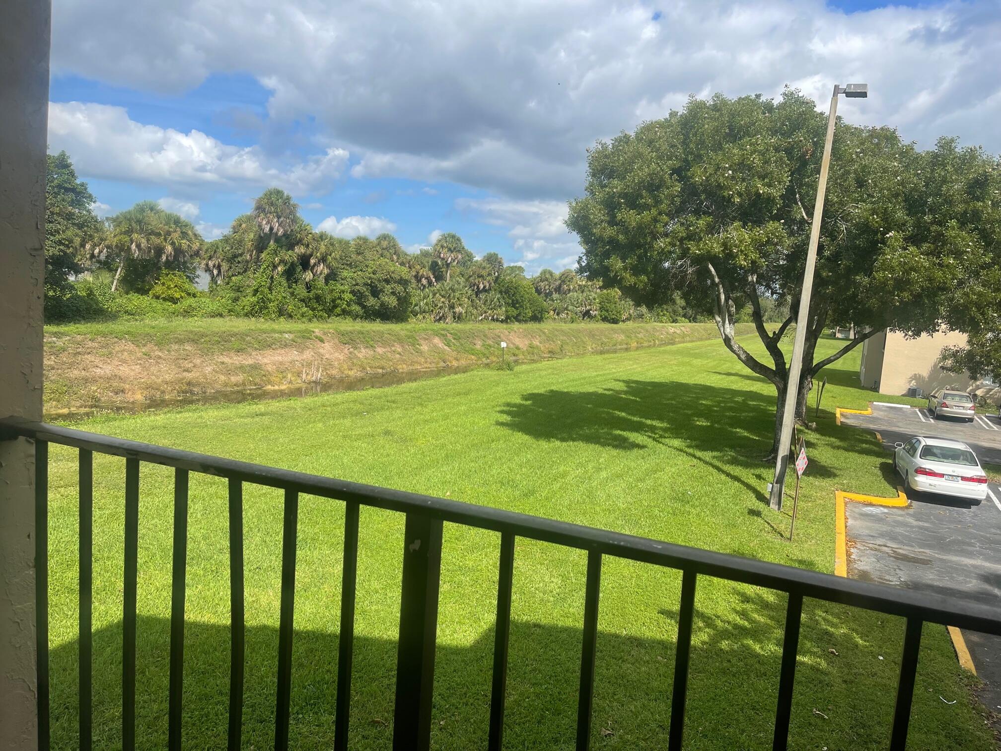 1089 Benoist Farms Road, Unit 207 West Palm Beach, FL 33411 - Photo 17 of 21 a view of swimming pool from a balcony