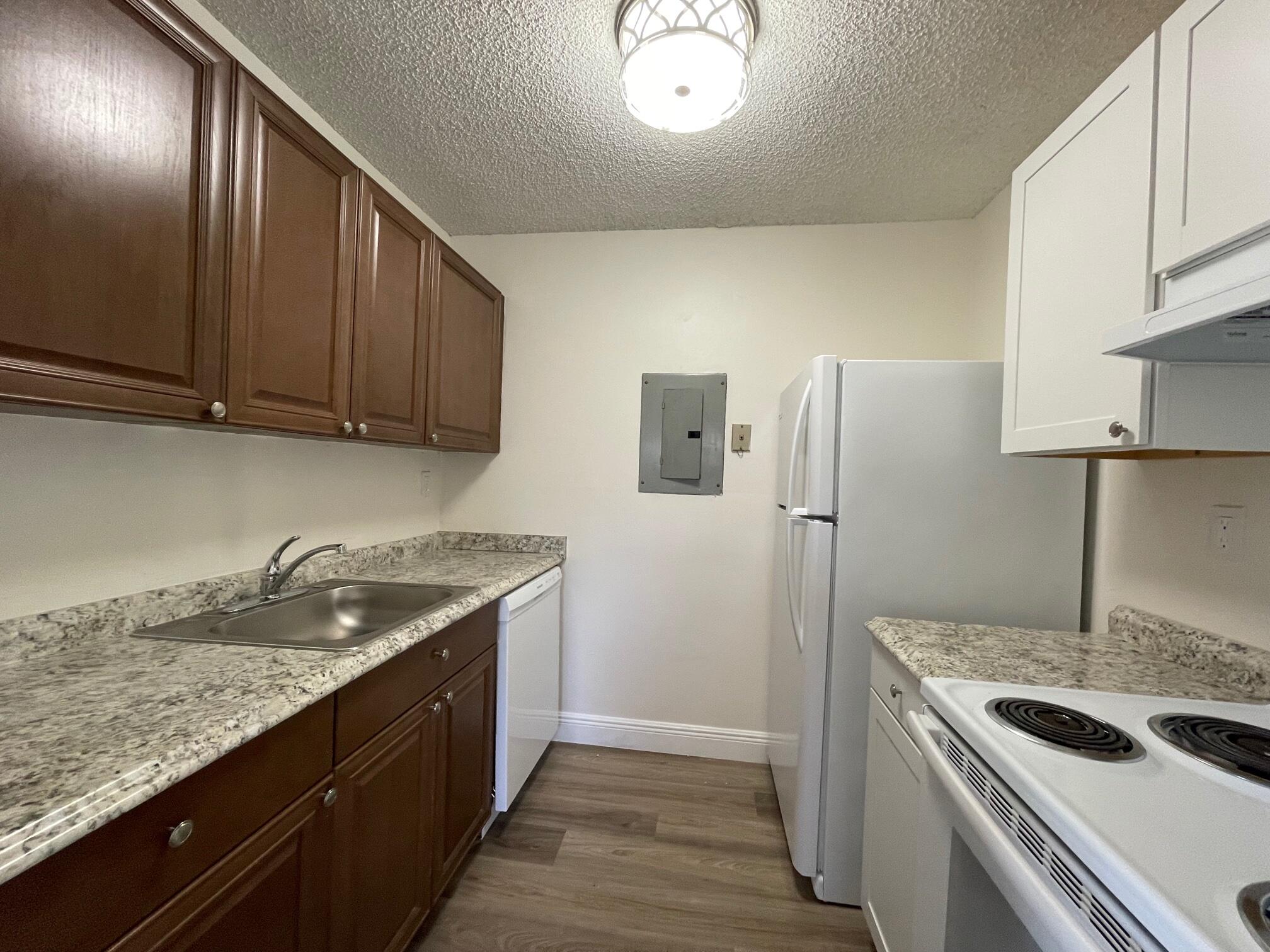 1089 Benoist Farms Road, Unit 207 West Palm Beach, FL 33411 - Photo 4 of 21 a kitchen with a stove and a refrigerator