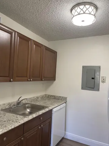 a kitchen with granite countertop cabinets and window