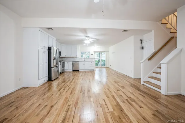 a view of a kitchen with wooden floor and electronic appliances