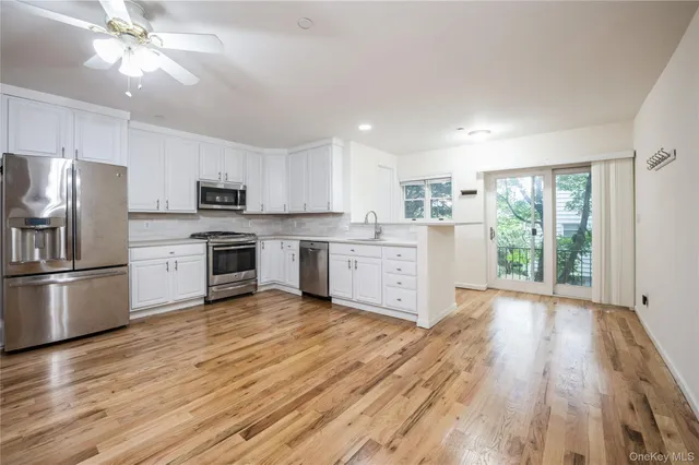 a kitchen with stainless steel appliances a stove top oven and a refrigerator