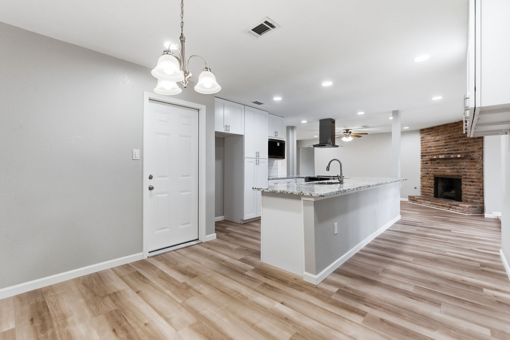 1620 Beachcomber Lane Houston, TX 77062 - Photo 21 of 27 a large kitchen with kitchen island a stove a sink a refrigerator and a fireplace