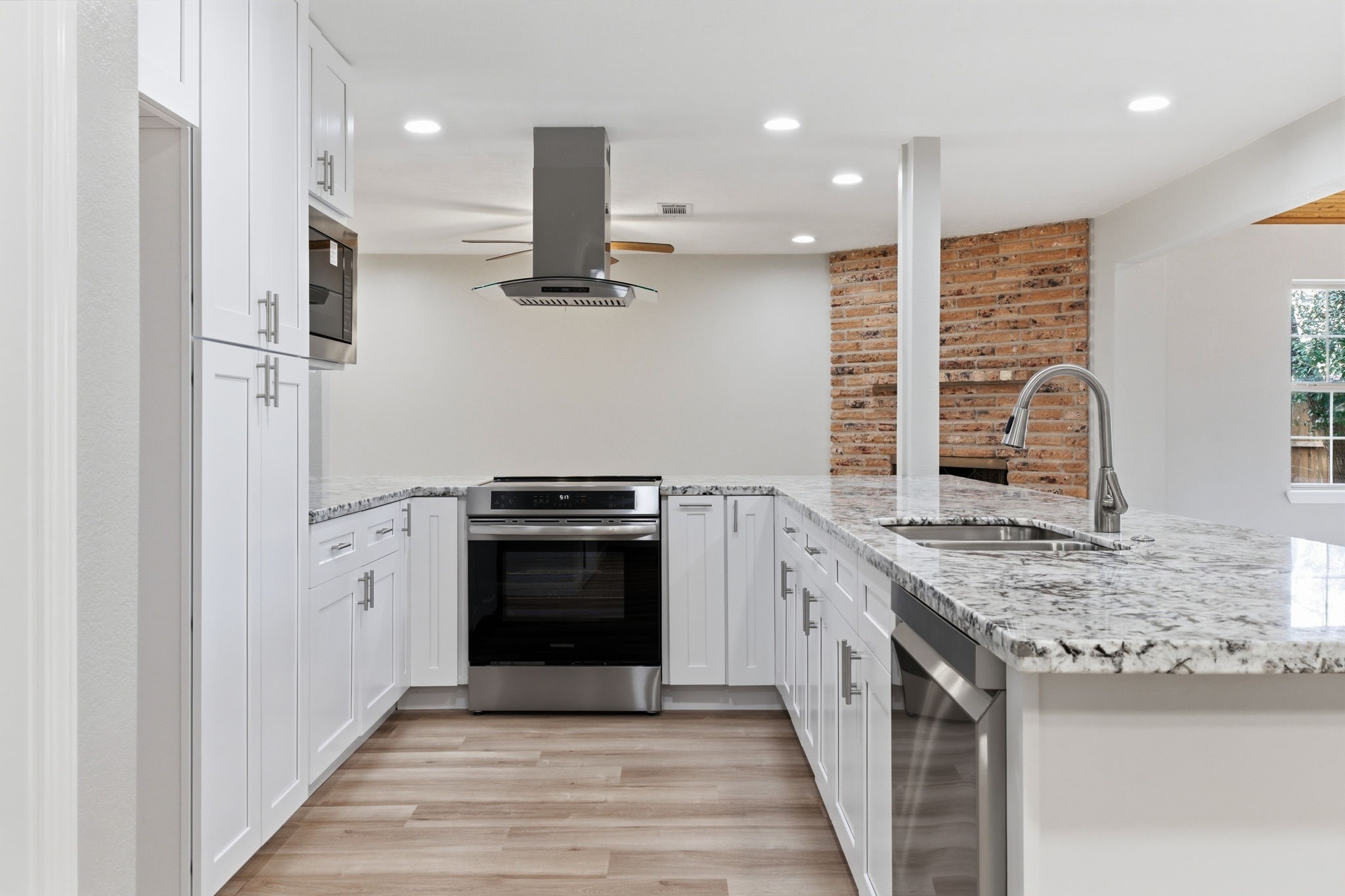 1620 Beachcomber Lane Houston, TX 77062 - Photo 5 of 27 a kitchen with stainless steel appliances granite countertop a stove a sink and a refrigerator