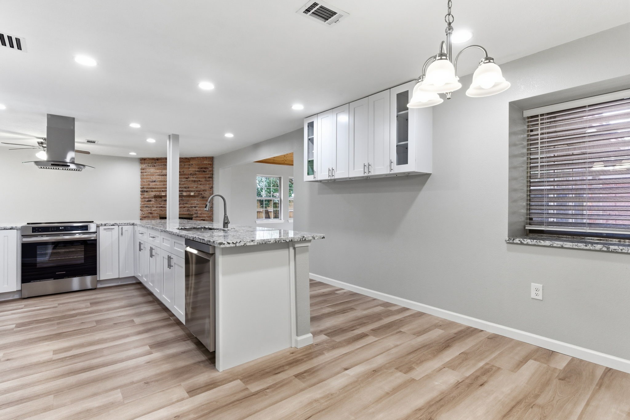 1620 Beachcomber Lane Houston, TX 77062 - Photo 6 of 27 a kitchen with stainless steel appliances granite countertop a stove cabinets and wooden floor
