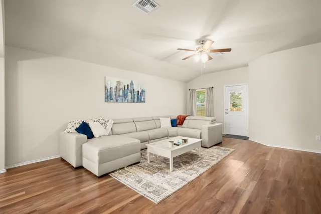 a living room with furniture and a large window