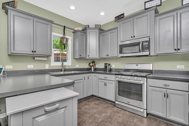 a kitchen with stainless steel appliances a refrigerator and a sink
