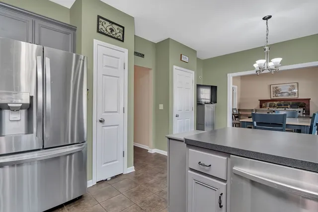 a kitchen with a table chairs stove and refrigerator