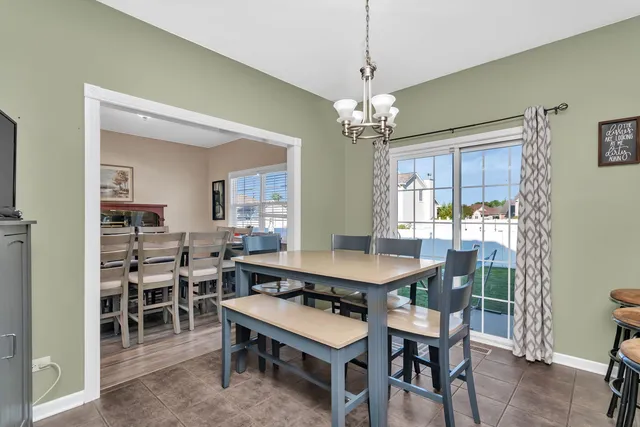 a view of a dining room with furniture and a chandelier