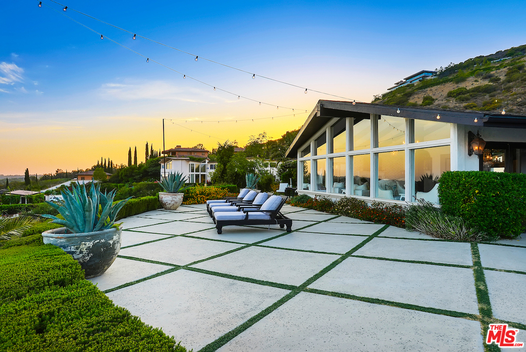 6355 Sycamore Meadows Drive Malibu, CA 90265 - Photo 3 of 50 a roof deck with table and chairs and potted plants