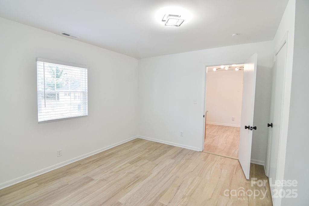 520 Denver Street Kannapolis, NC 28083 - Photo 13 of 14 an empty room with wooden floor and windows