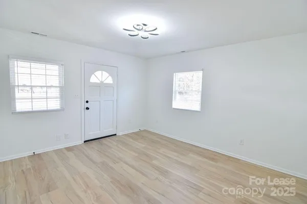 an empty room with windows and closet