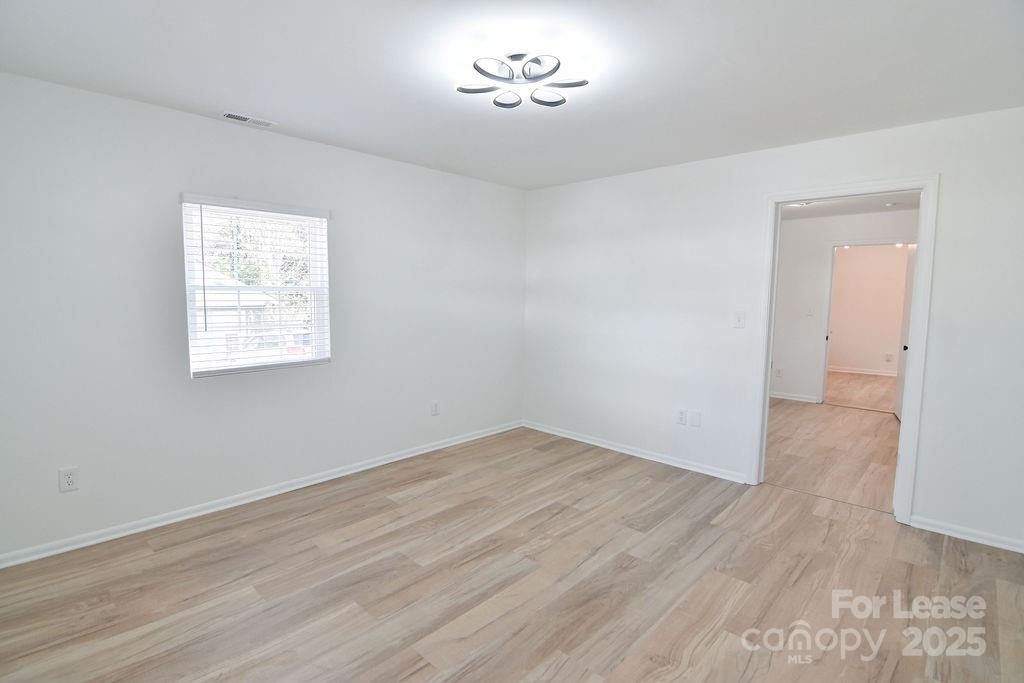 520 Denver Street Kannapolis, NC 28083 - Photo 3 of 14 wooden floor in an empty room with a window