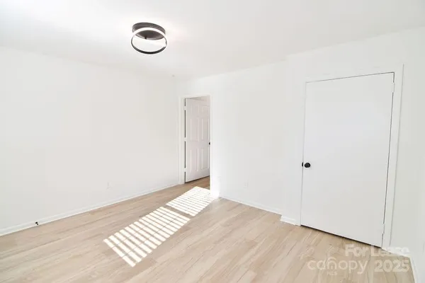 a view of a room with wooden floor