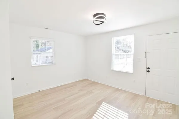 a view of an empty room with a window