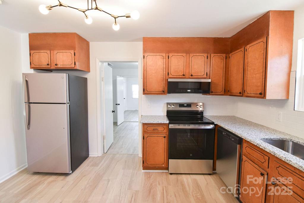 520 Denver Street Kannapolis, NC 28083 - Photo 7 of 14 a kitchen with granite countertop a refrigerator stove and sink