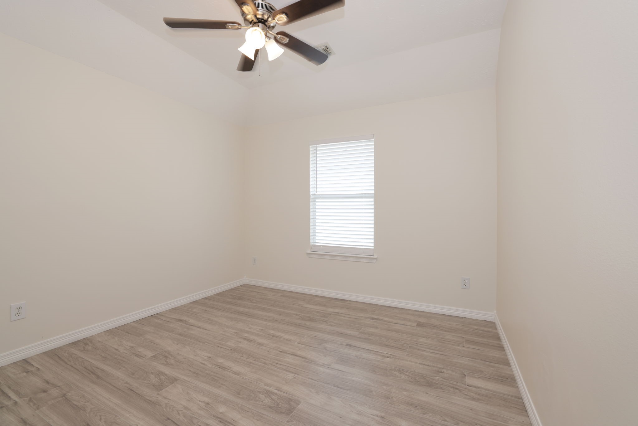 3031 Country Boy Court Spring, TX 77373 - Photo 25 of 35 an empty room with wooden floor fan and windows