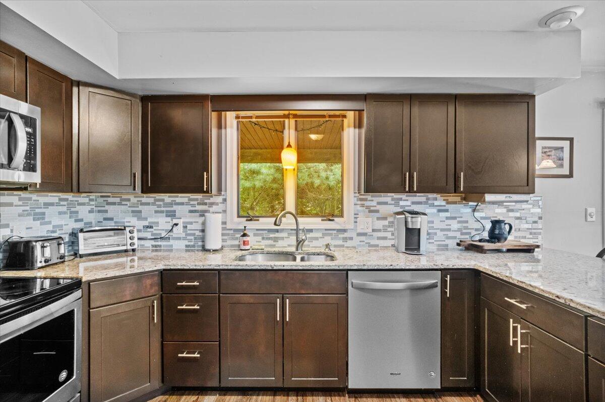 52 Hickory Road Lake Harmony, PA 18624 - Photo 12 of 36 a kitchen with a sink dishwasher a stove and cabinets