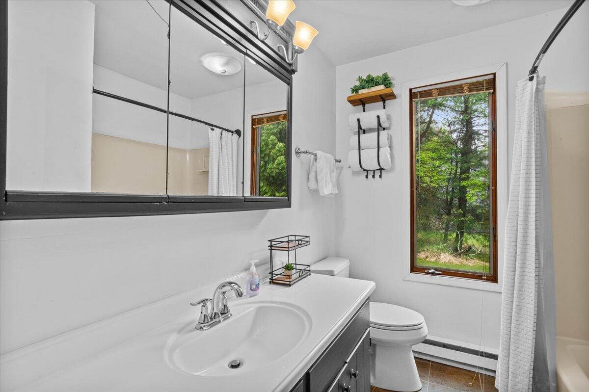 52 Hickory Road Lake Harmony, PA 18624 - Photo 16 of 36 a bathroom with a sink a toilet and a window