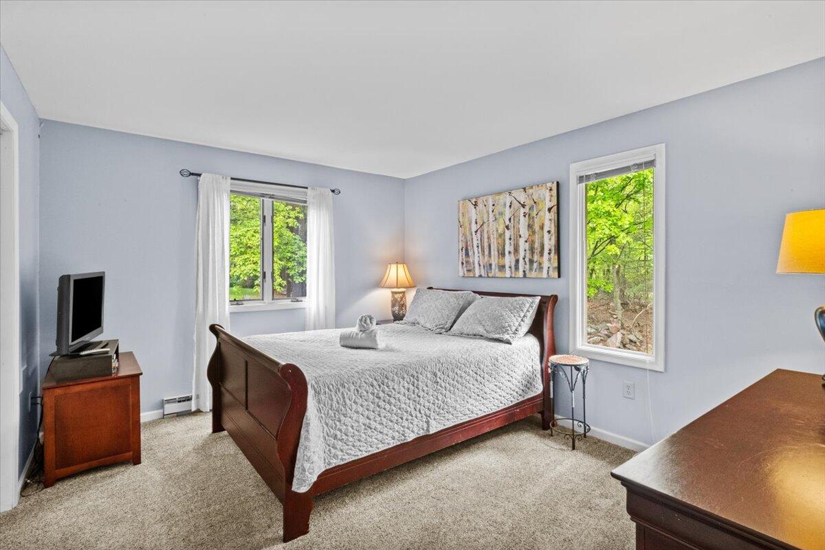 52 Hickory Road Lake Harmony, PA 18624 - Photo 18 of 36 a bedroom with a bed and a lamp on dresser