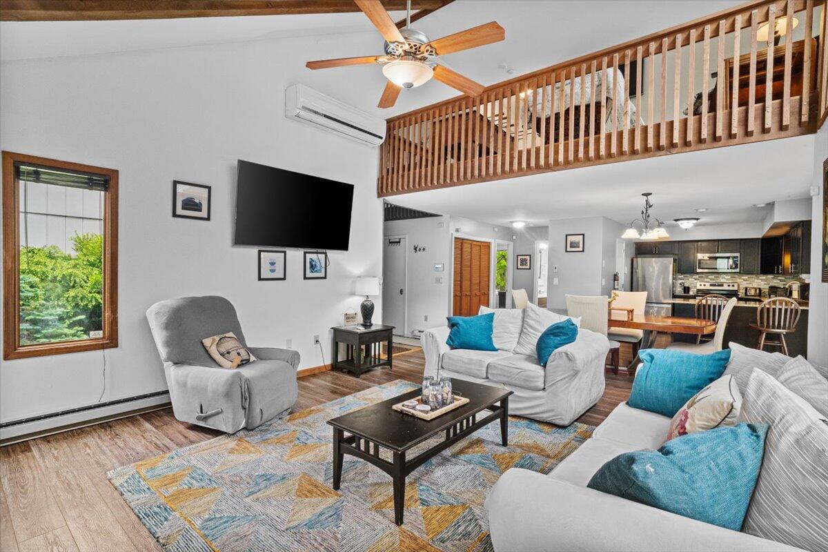 52 Hickory Road Lake Harmony, PA 18624 - Photo 8 of 36 a living room with furniture a flat screen tv and kitchen view