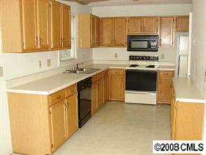 27038 Tidal Way, Unit C Tega Cay, SC 29708 - Photo 3 of 8 a kitchen with a sink a stove and a microwave